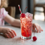 Served Shirley Temple drink with cherry garnish