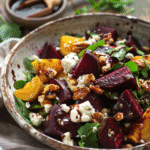 Roasted Beet & Goat Cheese Salad with Greens with roasted beets, goat cheese, walnuts, and mixed greens in a bowl