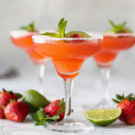virgin daiquiri mocktails served in glasses with strawberry, lime, and sugar rim garnish
