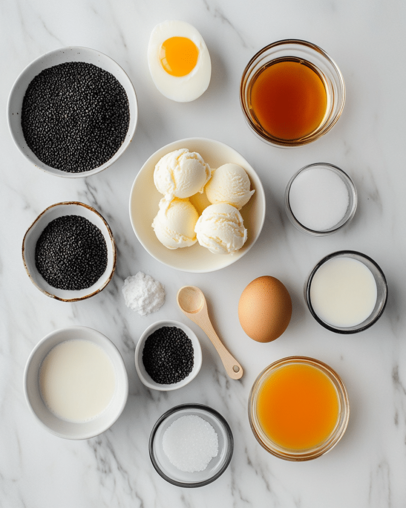 Black Sesame Ice Cream: How to Make the Best Dairy-Free Dessert 7 Black sesame ice cream ingredients including black sesame seeds, cream, milk, egg yolks, sugar, vanilla, and salt.