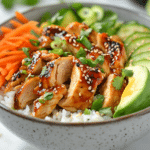 The Best Chicken Rice Bowl Recipe for a Delicious Meal at Home 6 Chicken pieces searing in a skillet with rice, vegetables, and soy garlic sauce ingredients ready for a chicken rice bowl.