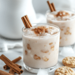 Homemade Horchata Recipe: How to Make the Best Horchata at Home 6 Served homemade horchata over ice with ground cinnamon, cinnamon sticks, and a white pitcher.